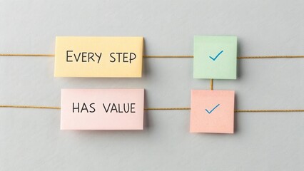 Colorful sticky notes with motivational phrases and check marks on gray background for productivity and planning concepts