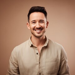 Obraz premium Smiling Young Man in Casual Shirt on Brown Background