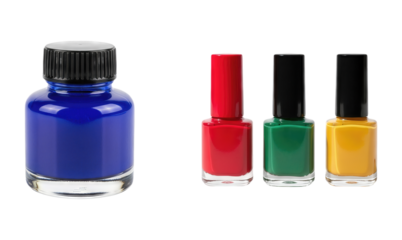 Assortment of colorful nail polish bottles vibrant blue red green and yellow with black caps isolated on white background beauty product manicure cosmetics