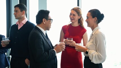 Diverse business colleagues in a friendly, professional conversation during a corporate networking event or New year party. Successful team members building connection and enjoying a social gathering - Powered by Adobe