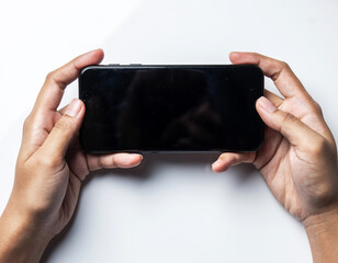 Two hands holding black smartphone in landscape mode