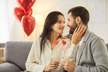 Loving happy Valentine day couple date, affectionate people holding red heart love symbol, close in...