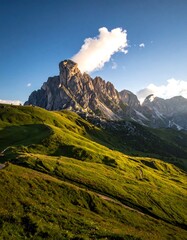 Majestic mountain peak against a clear blue sky, bathed in sunlight