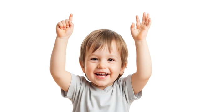 A cheerful toddler with brown hair raises both hands in an exuberant gesture, expressing joy and excitement with a big smile.
