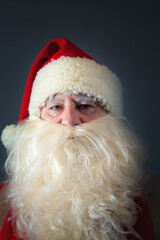 Close-up portrait of an authentic Santa Claus looking at the camera. Christmas concept.