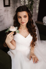 Portrait of a beautiful girl bride in a long wedding dress with an elegant hairstyle.