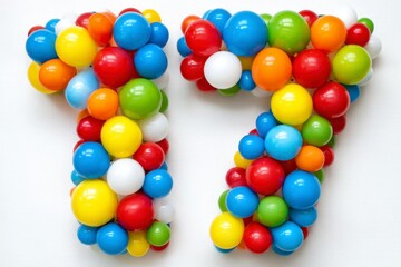 Obraz premium Colorful Number Seventeen Made of Bright Plastic Balls on White Background