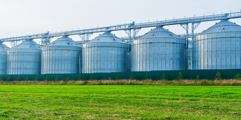 Grain silos storing agricultural harvest on a farm field
