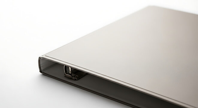 A close up shot of a silver binder with metal rings on a white surface in a studio setting ai generated