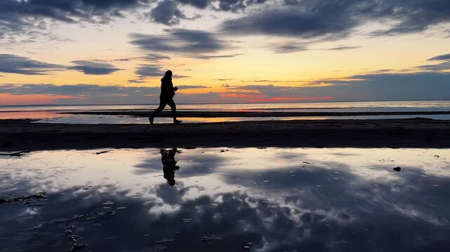 Motivated girl runs on the sea cost