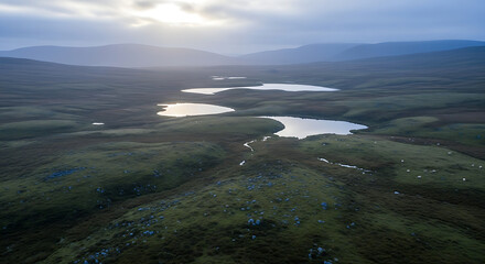 Aerial view of a landscape with lakes and mountains under a cloudy sky in a remote area at dusk ai generated