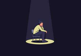 Person sitting in a spotlight, looking thoughtful.