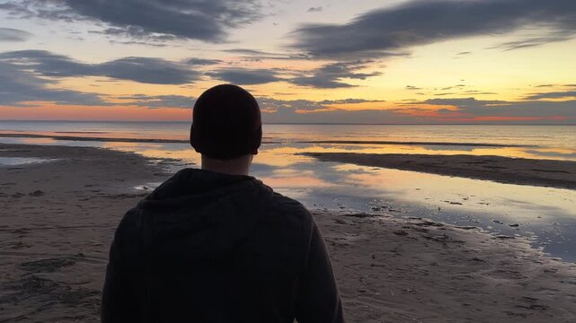 Man walks on the sea cost and fells freedom