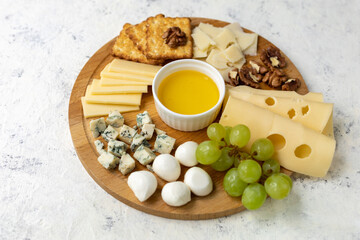 Gourmet cheese platter with grapes and honey dip variety