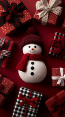 Snowman beside bright present boxes and decorative ribbons.