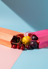 Pop Art Style Composition of Orange and Pink Bags Full of Summer Fruits.