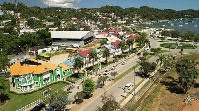 Aerial footage showing the port area with boats, buildings, and daily local life. Great atmosphere of a tropical coastal city