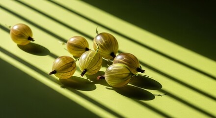 Sunlight-Kissed Gooseberries: A Delicate Composition On A Vibrant Green Surface