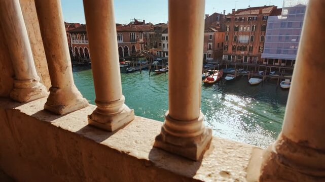 Cinematic view of the Grand Canal seen through a beautiful loggia in Venice, Veneto, Italy