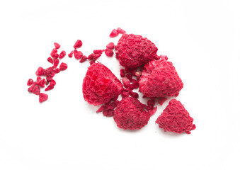 dried raspberries and raspberry pieces on a white background