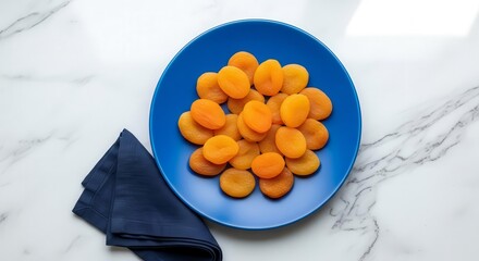 Vibrant Dried Apricot Pile On A Blue Plate Against A Stylish Marble Surface