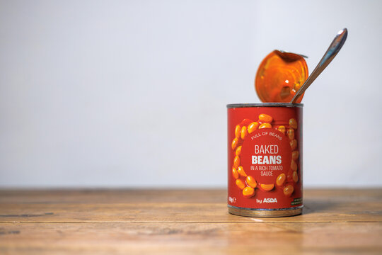A tin of baked beans opened with spoon in can from Asda
