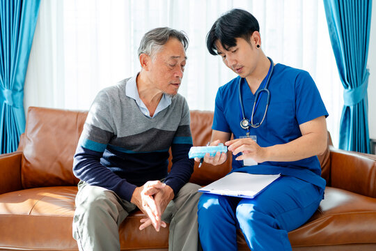 asian senior man consult supplement medicine vitamin and drug instructed by physiotherapist. home caregiver nurse visit retirement patient for health check up recovery process medical service