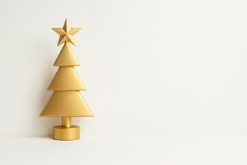 Minimal golden Christmas tree sculpture with star on neutral background symbol of elegance celebration and festive decor