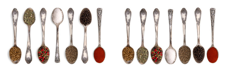 Set of antique metal spoons with spices and herbs: coriander, peppercorns, salt, and paprika...