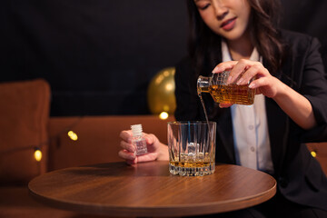 Closeup business woman holding a glass of whiskey