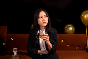 Closeup business woman holding a glass of whiskey