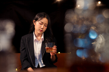 Closeup business woman holding a glass of whiskey