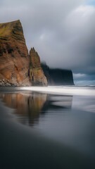 Dramatic Coastal Cliffs Meet Black Sand Beach Under Moody Skies