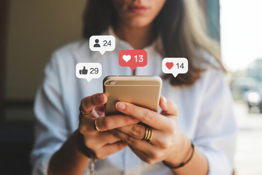 Woman using smartphone with social media notification icons