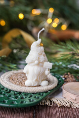 Handmade soy wax candles in the cozy room, Christmas lights in the background