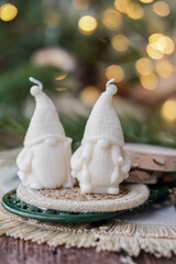 Handmade soy wax candles in the cozy room, Christmas lights in the background