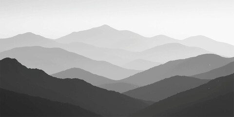 Misty mountain landscape with fog rolling over the hills at sunrise