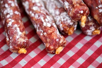 Concept of Parma cured meats, stuffed pork: variety of salamis displayed on the counter of a typical Parma shop