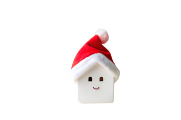 White ceramic house with smiling face wearing red Santa hat with pompom, isolated on a transparent background