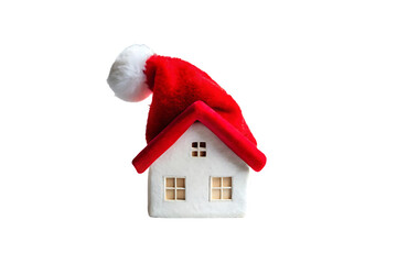 White miniature house figurine with dual windows, red Santa Claus hat draped over roof, festive ornament, isolated on a transparent background