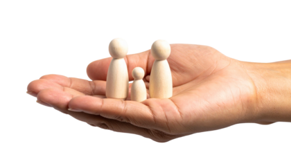 A hand cradles a wooden family figurine, symbolizing care and protection
