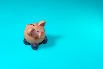 A piggy bank sits on a bright, solid blue background, ideal for concepts like saving money and...