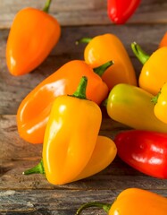 Colorful mini peppers on a wooden surface