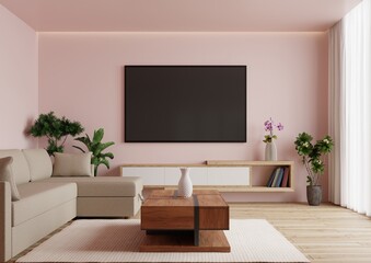 Large TV on the pink wall in the living room with a sofa and a beautiful wooden table.