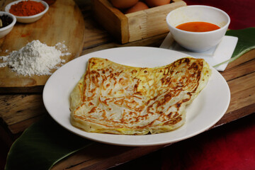 roti canai : Flaky Perfection: A light, pan-fried Malaysian flatbread with a crispy exterior and...