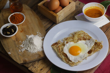 roti canai : Flaky Perfection: A light, pan-fried Malaysian flatbread with a crispy exterior and...