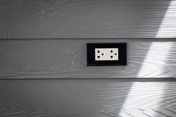 Gray wooden wall mounted electrical outlet
