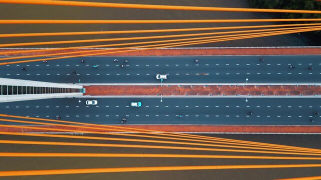 Symmetric modern cable-stayed bridge over Han river in Da Nang, Contemporary urban span connecting city across waterway 4k, aerial drone view, directly above perspective