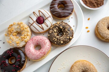 An assortment of beautifully glazed and decorated donuts on display