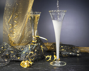 New Year concept, with bright light and champagne glass, abstract bokeh background